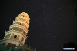 A meteor streaks across the sky during the Perseid meteor shower seen in Kaijiang County of Dazhou, southwest China's Sichuan Province, Aug. 12, 2015. The annual Perseid meteor shower reaches its peak on Aug. 12 and 13 this year. 