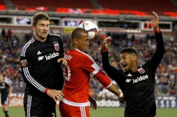 DC United defenders Bobby Boswell (L) and Sean Franklin double team New England Revolution forward Teal Bunbury.