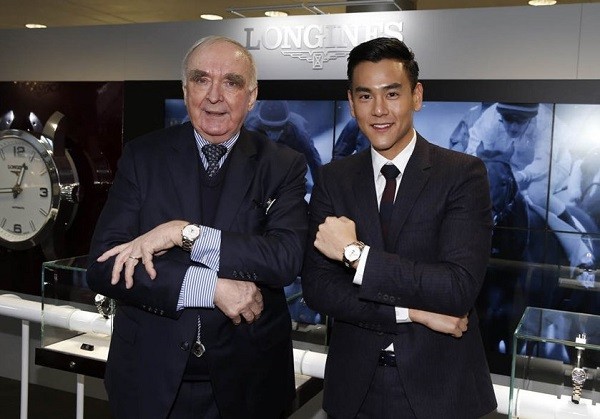 Eddie Peng shows off his Longines watch as he poses beside Longines president Walter von Känel in Hong Kong.