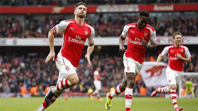Arsenal's Olivier Giroud (L) celebrates after a goal.