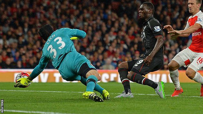 Liverpool's Christian Benteke (R) against Arsenal's Petr Cech