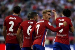 Atletico Madrid's Antoine Griezmann celebrates with teammates after scoring a goal against Las Palmas during their opener.