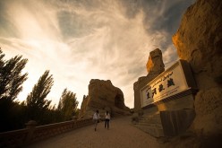 A couple of tourists visit the Jiaohe Ruins in Turpan’s Yarnaz Valley.