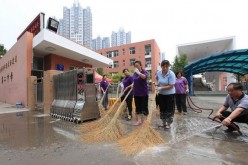 Personnel clean the school grounds prior to the opening of classes in Binhai in Tianjin.
