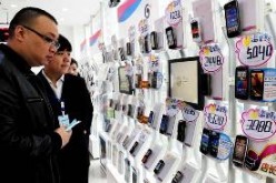 Buyers look at smartphones on display at a China Mobile Ltd. store in Zhengzhou, Henan Province.