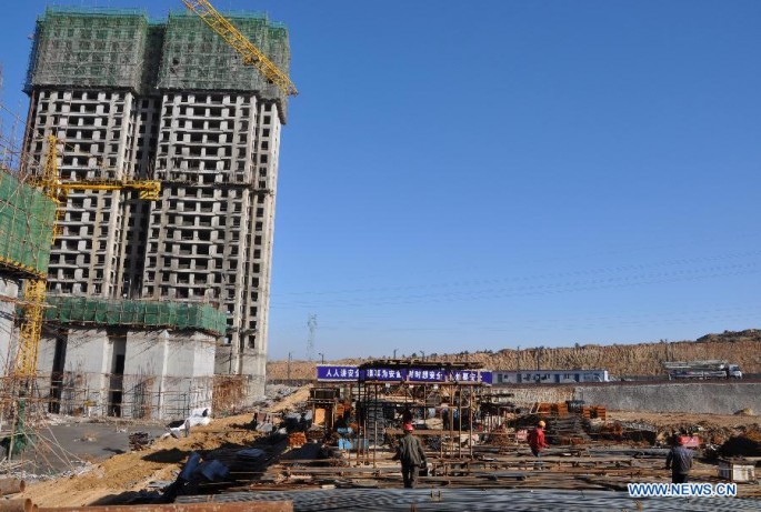 Laborers work at the construction site of a low-cost housing project in Ordos City in China’s Inner Mongolia Region.