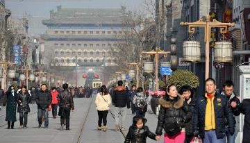 Tourists visit the Qianmen Street, a well-known commercial street in Beijing.