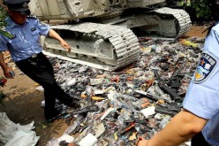 Police destroy illegal rifles in Shanghai in this June 12, 2012 photo.