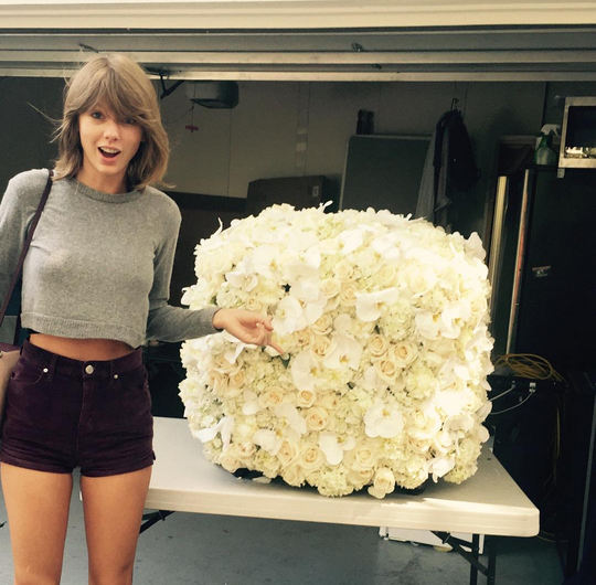 "Bad Blood" singer Taylor Swift poses beside the white flowers Kanye West gave her days after the 2015 MTV Video Music Awards.