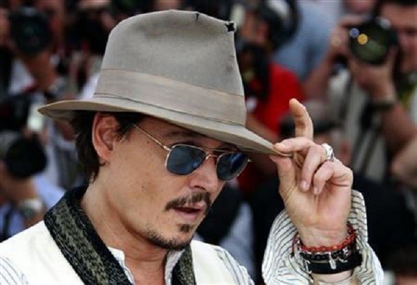 Cast member Johnny Depp poses during a photocall for the film ''Pirates Of The Caribbean: On Stranger Tides'' at the 64th Cannes Film Festival, May 14, 2011.