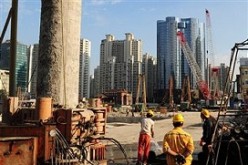 Chinese builders carry out construction in Shanghai as part of the infrastructure projects of the government.