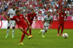 Bayern Munich's Thomas Müller scores a penalty kick goal against Bayer Leverkusen during their Bundesliga match, Aug. 29.