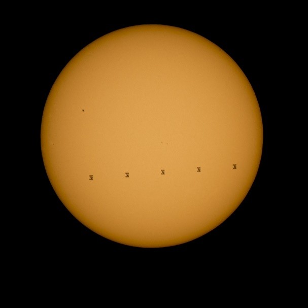 This composite image made from five frames shows the International Space Station, with a crew of nine onboard, in silhouette as it transits the sun at roughly 5 miles per second, Sunday, Sept. 6, 2015, Shenandoah National Park, Front Royal, VA.