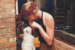 Taylor Swift playing with her cat, a photo she uploaded on Instagram.