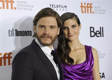 Cast member Daniel Bruehl poses on the red carpet with girlfriend Felicitas Rombold before a screening of the film ''Rush'' at Roy Thomson Hall during the 38th Toronto International Film Festival in Toronto September 8, 2013.
