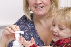 Woman Applying Sanitizer to Child's Hands