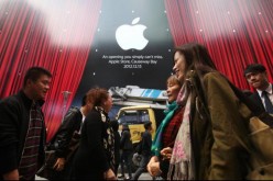 Shoppers walk past an Apple Store at Hysan Place in Causeway Bay, Hong Kong.