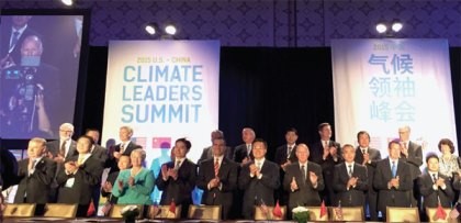 Local officials from China and the United States cheer after signing the Climate Leaders declaration at the "China-U.S. Climate-Smart/Low Carbon Cities Summit," held on Sept. 15-16, in Los Angeles.