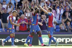 Crystal Palace players celebrate with their star midfielder Bakary Sako during one of his recent goals.