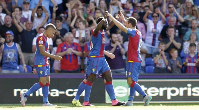 Crystal Palace players celebrate with their star midfielder Bakary Sako during one of his recent goals.