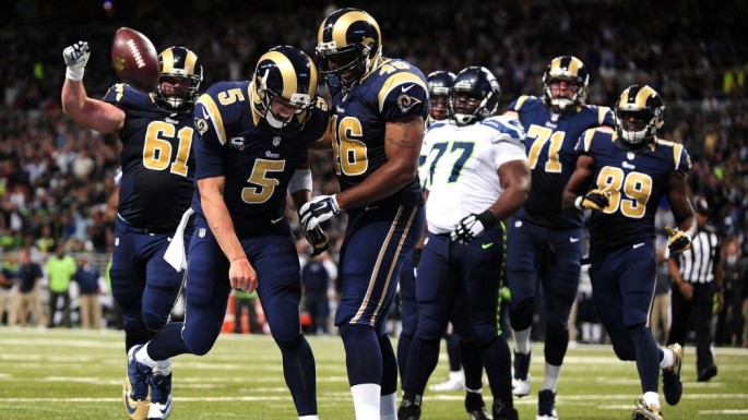St. Louis Rams quarterback Nick Foles (#5) celebrate with teammates during their last game against the Seattle Seahawks.