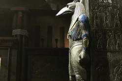 Bryan Singer is looking at an Egyptian god statue at the set of his 