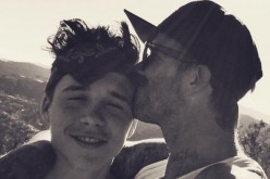 Soccer icon David Beckham plants a kiss on the forehead of his eldest son Brooklyn during one of their outdoor bonding moments.