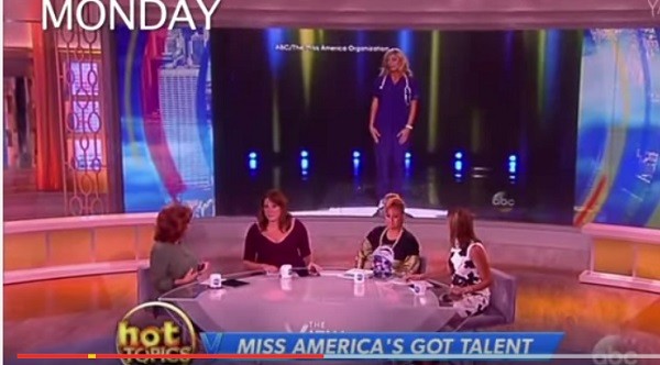 Miss Colorado Kelley Johnson is pictured on the screen behind "The View" hosts as they question  her choice of monologue for the Miss America pageant.