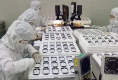 Workers inspect products at an Apple assembly plant in China.