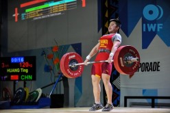 Huang Ting lifts with all her might as she participates in the 2015 IWF Youth World Championships held in Lima, Peru.