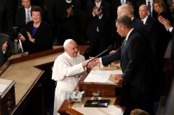 United States House Speaker John Boehner shakes hands with Pope Francis.