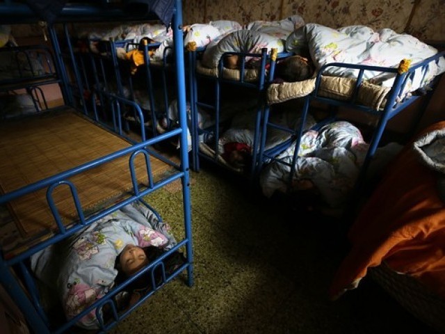 Some left-behind children sleep in dorms in their kindergartens because their parents leave them to work in the city.