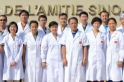 The Chinese medical team sent by the country to help with Ebola treatment pose for picture outside Hôpital De L'amitié Sino-Guinéenne in Guinea in West Africa.