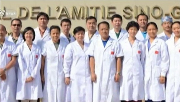 The Chinese medical team sent by the country to help with Ebola treatment pose for picture outside Hôpital De L'amitié Sino-Guinéenne in Guinea in West Africa.