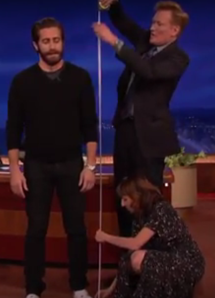 Conan O’Brien and "Mystery Show" host Starlee Kine measure how tall "Everest" star Jake Gyllenhaal is.