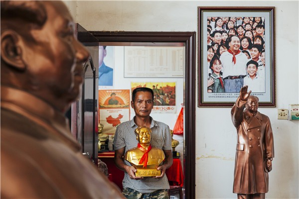 A man holds a bust of Mao Zedong, the former chairman of the Communist Party of China, inside a souvenir shop in Shaoshan, Mao’s birthplace.