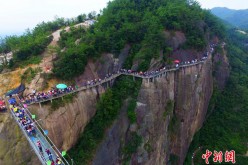 Thousands of people on and near the all-glass bridge, which is located in Pingjiang County, in central China's Hunan Province. 