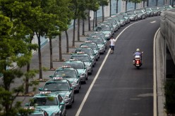 A man walks past a streak of taxis in Hangzhou, Zhejiang Province.