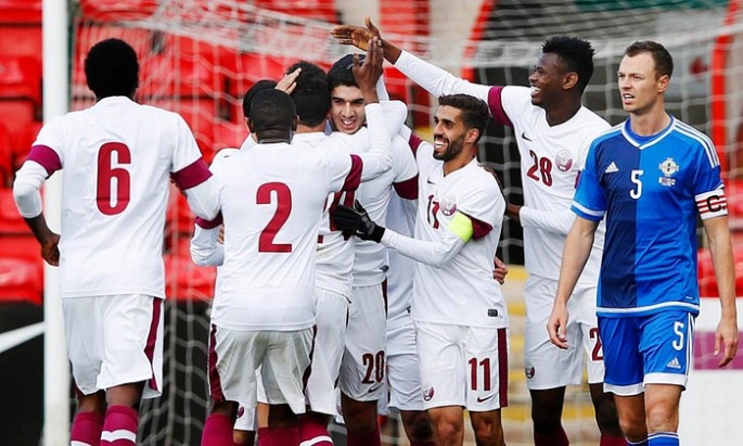Qatar celebrates a goal in a friendly against Northern Ireland.