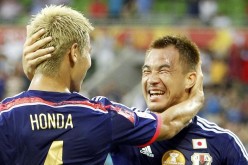 Japan's Keisuke Honda celebrates with teammate Shinji Okazaki.