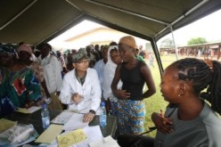 A doctor belonging to the Chinese medical team attends to patients in an African town.