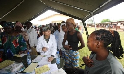 A doctor belonging to the Chinese medical team attends to patients in an African town.