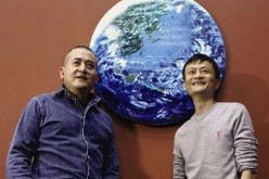 Zeng Fanzhi and Jack Ma pose with their oil painting entitled 