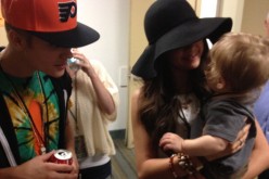 Justin Bieber and Selena Gomez relax backstage at a Phish concert on August 15, 2012 in Long Beach, California.