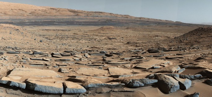 A view from the "Kimberly" formation on Mars taken by NASA's Curiosity rover. The strata in the foreground dip towards the base of Mount Sharp, indicating the ancient depression that existed before the larger bulk of the mountain formed.
