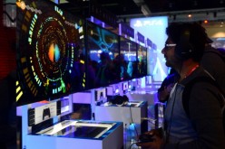 A gamer plays 'Entwined' on Sony's PS4 at annual E3 video game extravaganza in Los Angeles, California on June 10, 2014, where Microsoft and Sony are battling for the hearts of hard core gamers whose devotion could determine whether Xbox One or PlayStatio