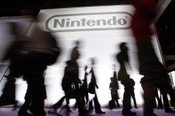 Attendees walk past the Nintendo of America Inc. booth during an Expo in Los Angeles 