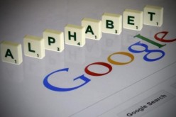 Letters spell the word ''Alphabet'' as they are seen on a computer screen with a Google search page