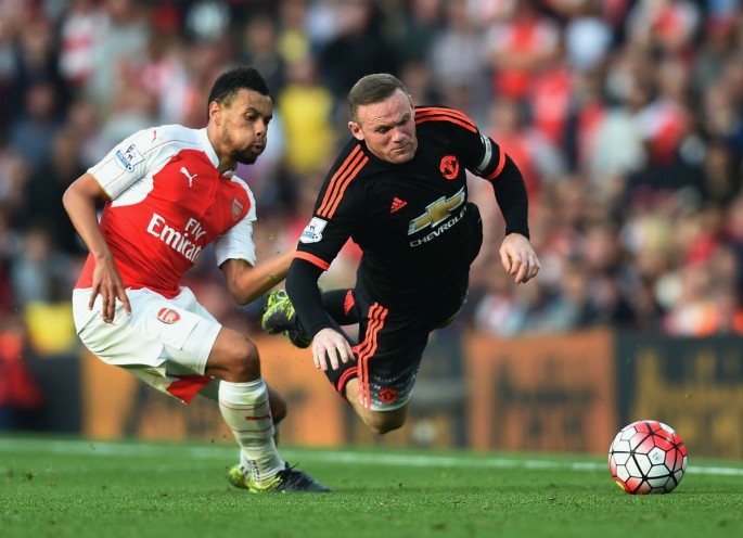 Wayne Rooney of Manchester United is tackled by Francis Coquelin of Arsenal.