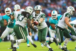 Ryan Fitzpatrick (#14) of the New York Jets hands off to teammate Chris Ivory (#33) during their game against the Miami Dolphins.